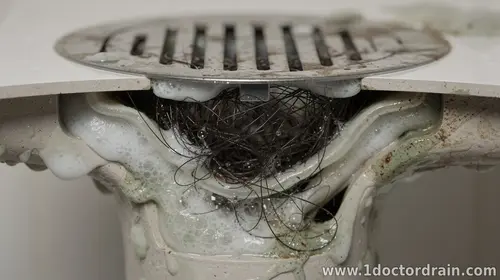 Shower Drain Clogs: Hair, Soap Scum, and Biofilm Explained